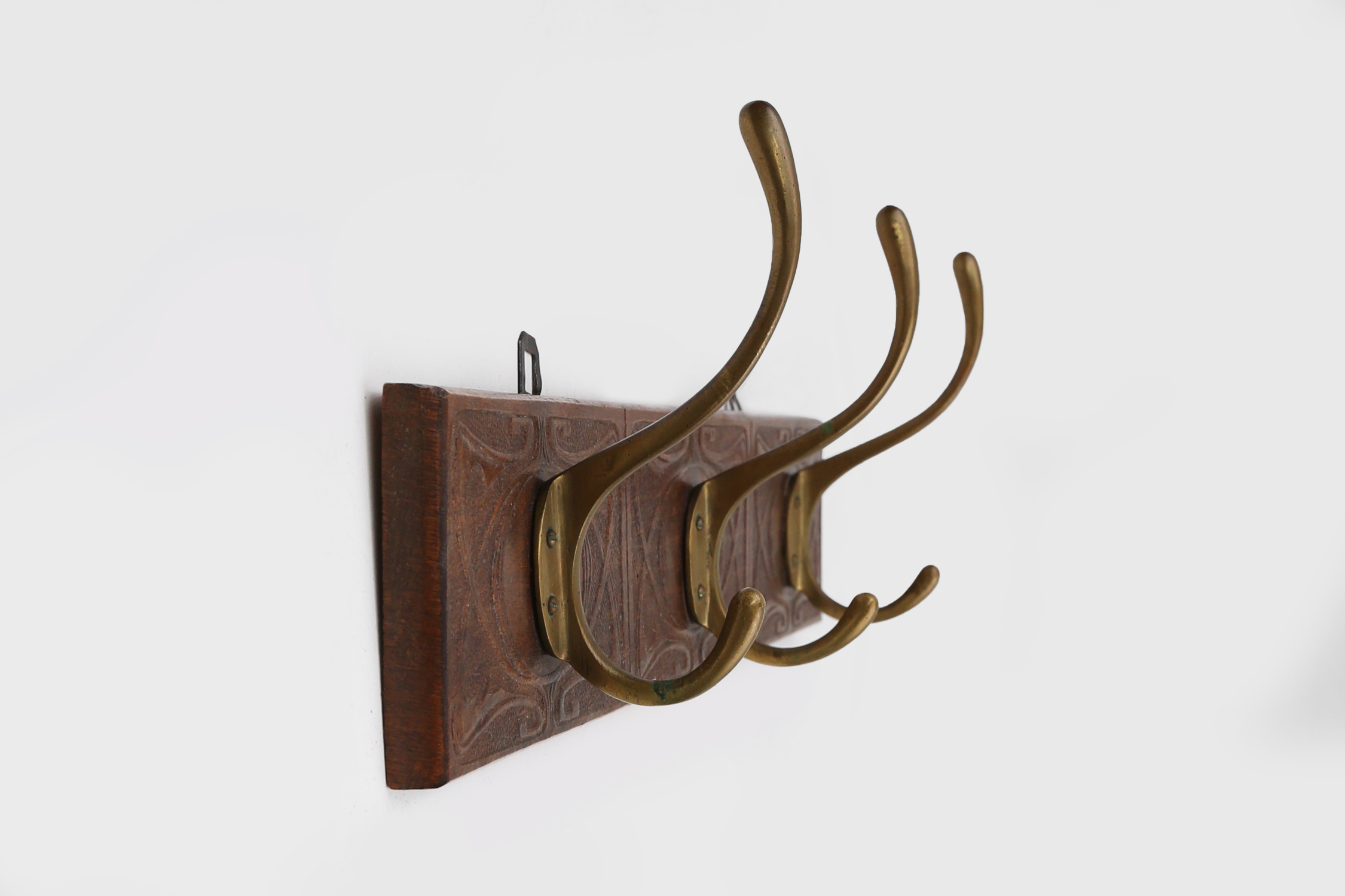 Art Nouveau wall coat rack in carved wood with brass, France ca. 1910thumbnail